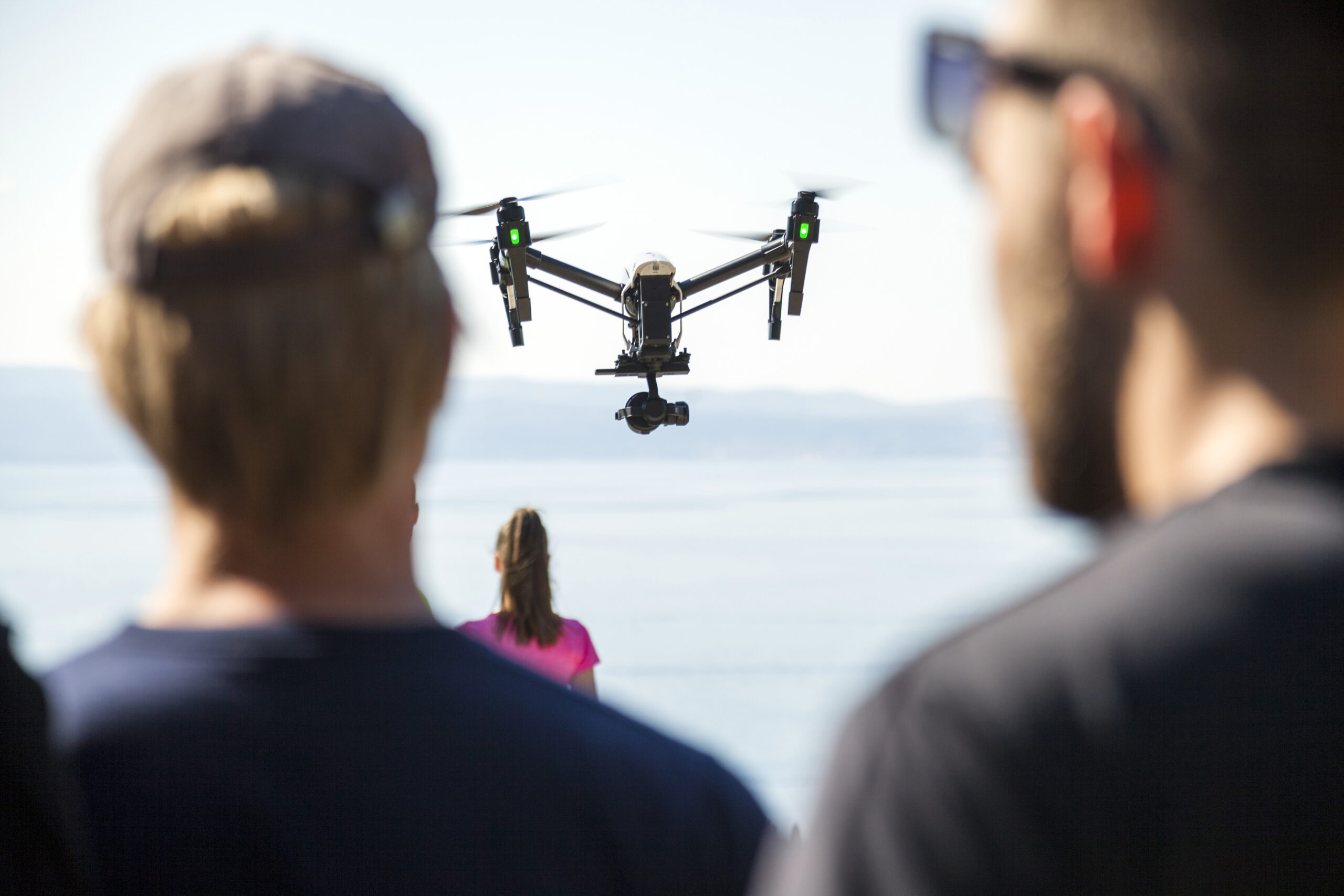 rear view of man and woman looking at drone flying 2025 04 04 17 34 48 utc scaled