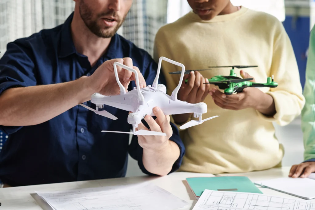 teacher showing how to turn on quadcopter 2025 03 09 16 14 59 utc